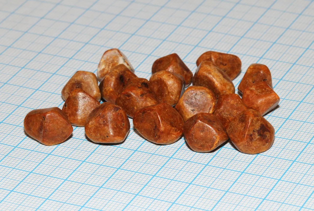 Gallstones removed from one patient, on a millimetre grid